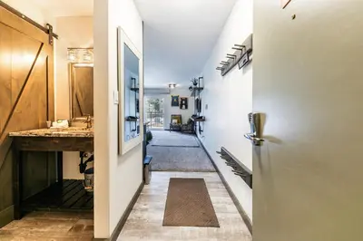 a hallway with a door and a hallway with a sink at Modern Studio Deluxe #231 at Donner Lake Village in Truckee