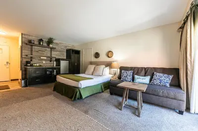 a hotel room with a bed and a couch at Modern Studio Deluxe #231 at Donner Lake Village in Truckee