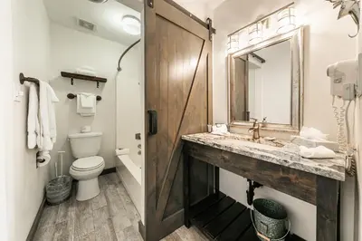 a bathroom with a sink and a toilet and a mirror at Modern Studio Deluxe #231 at Donner Lake Village in Truckee