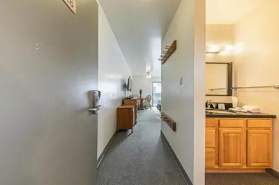 a hallway leading to a kitchen with a door at Cozy Studio #226 at Donner Lake Village in Truckee