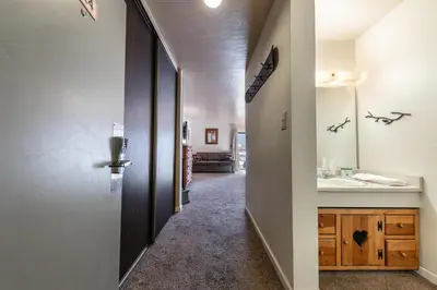 a hallway of a bathroom with a sink and a mirror at Cozy Studio w/Partial Lake view #224 at Donner Lake Village in Truckee