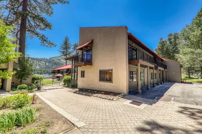 an exterior view of a building with trees at Cozy Studio w/Partial Lake view #224 at Donner Lake Village in Truckee