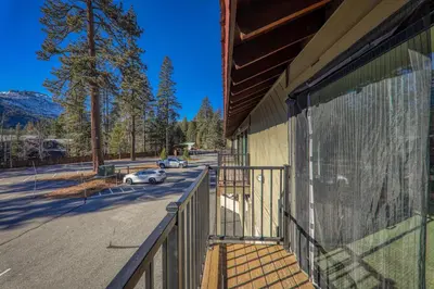 a balcony of a building with a car on a street at Cozy Studio w/ Partial Lake view #223 at Donner Lake Village in Truckee
