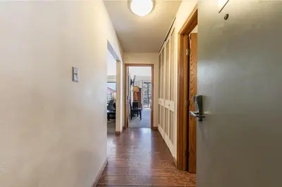 a hallway with a door and a room with a table at Spacious 1BR Condo w/Partial Lake View #222 at Donner Lake Village in Truckee