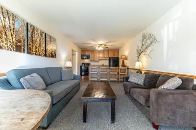 a living room with couches and a table at Spacious 1BR Condo w/Partial Lake View #222 at Donner Lake Village in Truckee