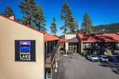 a town with a lake village sign on the side of a building at Cozy Studio wKitchen #217 at Donner Lake Village in Truckee