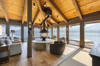 a living room with a couch and a table and windows at Cozy Studio wKitchen #217 at Donner Lake Village in Truckee