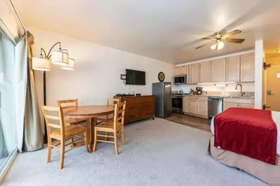 a kitchen and dining room with a table and chairs at Studio w/Kitchen 2nd Floor #213 at Donner Lake Village in Truckee