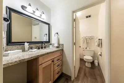 a bathroom with a sink and a toilet and a mirror at Studio w/Kitchen 2nd Floor #213 at Donner Lake Village in Truckee