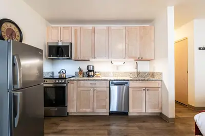 a kitchen with wooden cabinets and stainless steel appliances at Studio w/Kitchen 2nd Floor #213 at Donner Lake Village in Truckee