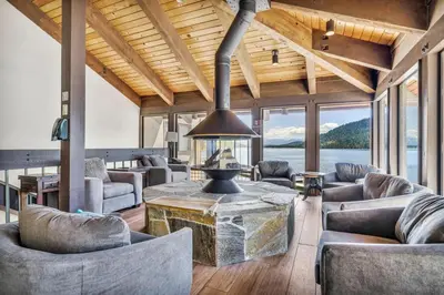 a living room with couches and a large fireplace at Cozy Studio w/Kitchen #112 at Donner Lake Village in Truckee