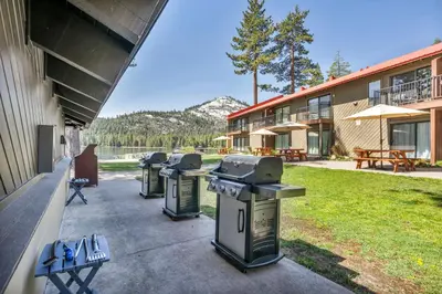 a row of trash cans sitting outside of a building at Cozy Studio w/Kitchen #112 at Donner Lake Village in Truckee