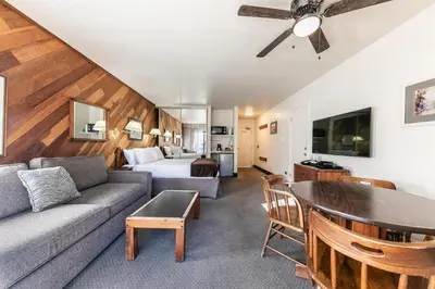 a living room with a couch and a bed at Homey 1st Floor Studio #135 at Donner Lake Village in Truckee