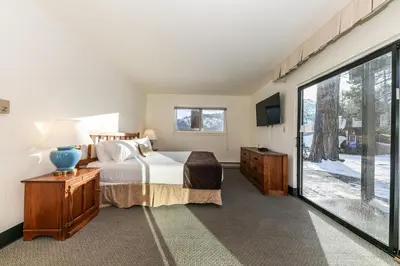 a bedroom with a bed and a large window at Spacious 1BR Condo w/ Lake View #136 at Donner Lake Village in Truckee