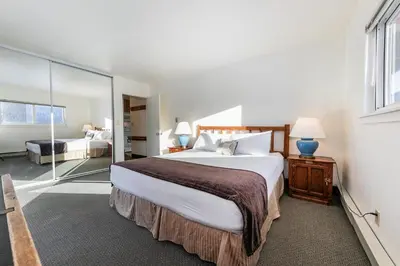 a bedroom with a large bed and a large window at Spacious 1BR Condo w/ Lake View #136 at Donner Lake Village in Truckee