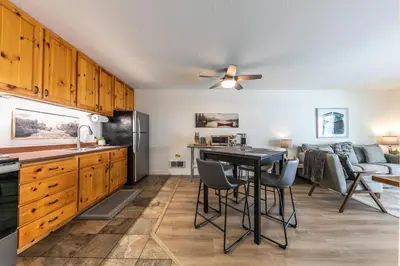 a kitchen and living room with a table and chairs at Inviting King Deluxe 1 BR Condo W/Lake view #141 at Donner Lake Village in Truckee