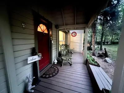a front porch of a house with a red door at Twain Harte Lake, pool/hot tub, by skiing/Yosemite in Twain Harte