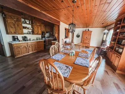 a dining room with a wooden table and chairs at Twain Harte Lake, pool/hot tub, by skiing/Yosemite in Twain Harte