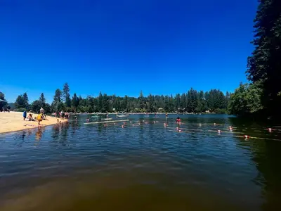 a group of people on the shore of a lake at Twain Harte retreat w/ lake access, ski/Yosemite in Twain Harte