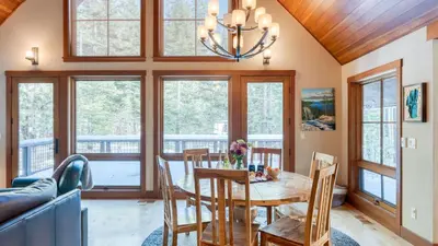 a dining room with a table and chairs and windows at Minutes to Ski Resorts 5min Walk to Lake Sunnyside Ward Creek by AvantStay in Tahoe City