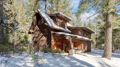 a log cabin in the woods in the snow at Minutes to Ski Resorts 5min Walk to Lake Sunnyside Ward Creek by AvantStay in Tahoe City