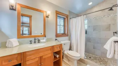a bathroom with a toilet and a sink and a shower at Minutes to Ski Resorts 5min Walk to Lake Sunnyside Ward Creek by AvantStay in Tahoe City
