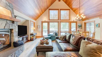 a living room with a couch and a fireplace at Minutes to Ski Resorts 5min Walk to Lake Sunnyside Ward Creek by AvantStay in Tahoe City
