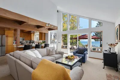 a living room with a couch and a table at Waves End Lakefront - 3BR Tahoe Vista w Private Sandy Beach, Walk to Town! in Tahoe Vista