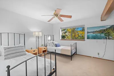 a bedroom with two beds and a ceiling fan at Waves End Lakefront - 3BR Tahoe Vista w Private Sandy Beach, Walk to Town! in Tahoe Vista