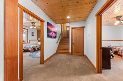 a hallway in a house with a bedroom at Copperleaf Lodge by Tahoe Getaways - Updated 5BR Alpine Meadows Chalet w Private Hot Tub, Ski Shuttle! in Alpine Meadows