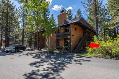 a house with a truck parked in front of it at Cozy Cabin-Style Condo in Central Location in Mammoth Lakes