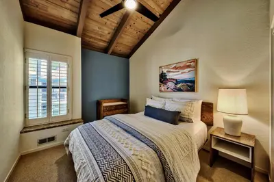 a bedroom with a bed and a window at Lakeland Village 620 - Beachfront Bliss in South Lake Tahoe