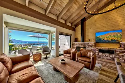 a living room with leather furniture and a flat screen tv at Lakeland Village 620 - Beachfront Bliss in South Lake Tahoe