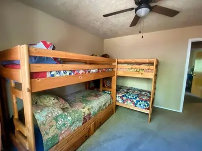 two bunk beds in a room with a ceiling fan at Read Haven 3 Bedroom, 1.5 Bath in Twain Harte