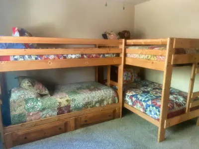 a bedroom with two bunk beds and a bed at Read Haven 3 Bedroom, 1.5 Bath in Twain Harte