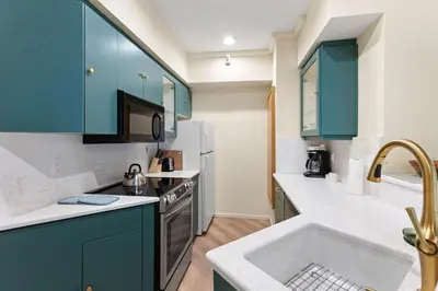 a kitchen with blue cabinets and a sink at Palisades Tahoe Lodge Rentals One Bedroom #120 in Olympic Valley