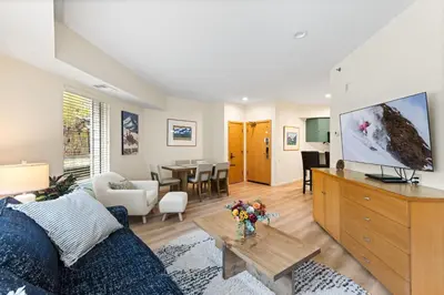 a living room with a couch and a tv at Palisades Tahoe Lodge Rentals One Bedroom #120 in Olympic Valley