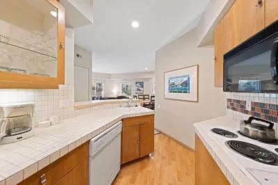a large kitchen with a sink and a stove at Palisades Tahoe Lodge Rentals One Bedroom #120 in Olympic Valley