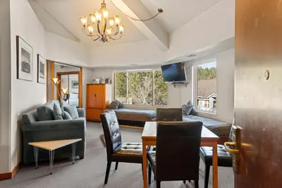 a living room with a table and a dining room at Palisades Tahoe Lodge Rentals Premium One Bedroom #321 in Olympic Valley