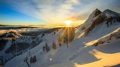 a snow covered mountain with the sun shining on it at Palisades Tahoe Lodge Rentals Premium One Bedroom #321 in Olympic Valley