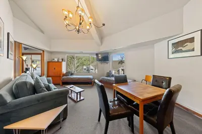 a living room with a couch and a table at Palisades Tahoe Lodge Rentals Premium One Bedroom #321 in Olympic Valley