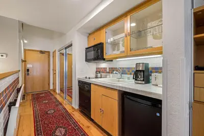 a kitchen with a sink and a counter top at Palisades Tahoe Lodge Rentals Studio Loft #307 in Olympic Valley