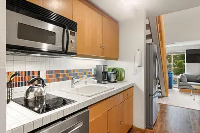 a kitchen with a sink and a microwave at Palisades Tahoe Lodge Rentals Studio Loft #308 in Olympic Valley