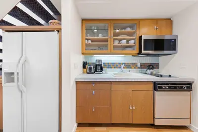 a kitchen with a sink and a microwave at Palisades Tahoe Lodge Rentals Studio Loft #310 in Olympic Valley