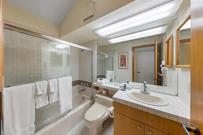 a bathroom with a sink and a toilet and a tub at Palisades Tahoe Lodge Rentals Studio Loft #317 in Olympic Valley