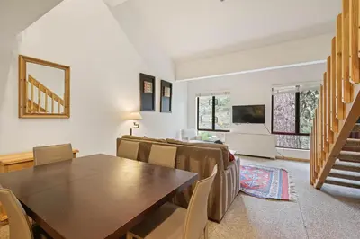 a living room with a table and chairs and a couch at Palisades Tahoe Lodge Rentals Studio Loft #345 in Olympic Valley