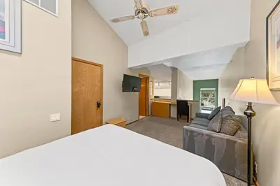 a hotel room with a bed and a couch at Palisades Tahoe Lodge Rentals Studio Loft #331 in Olympic Valley
