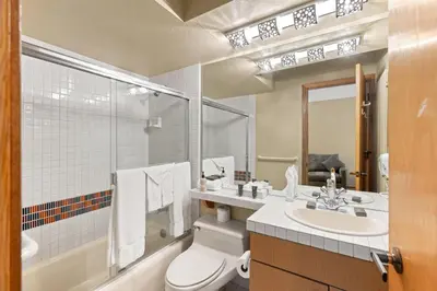 a bathroom with a toilet and a sink and a tub at Palisades Tahoe Lodge Rentals Studio Loft #331 in Olympic Valley