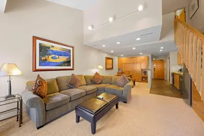 a living room with a couch and a table at Studio Loft #348 in Olympic Valley
