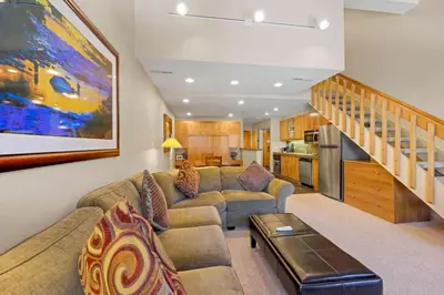 a living room with a couch and a table at Studio Loft #348 in Olympic Valley